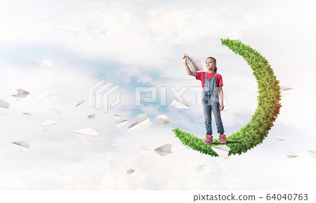 Concept of careless happy childhood with girl on green moon Concept of careless happy childhood with girl on green moon 64040763
