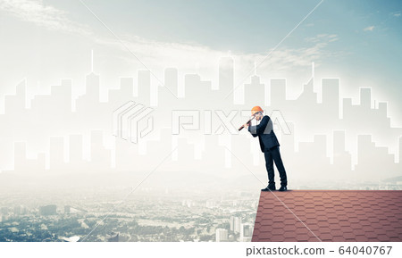 Engineer man standing on roof and looking in spyglass. Mixed med Engineer man standing on roof and looking in spyglass. Mixed med 64040767