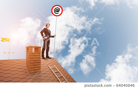 Businessman in suit and helmet presenting email concept on signbaord. Mixed media Businessman in suit and helmet presenting email concept on signbaord. Mixed media 64040846
