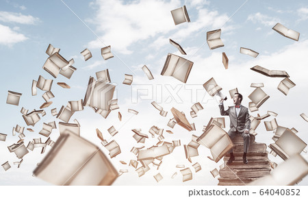 Businessman floating in sky and announcing something in loudspea 64040852