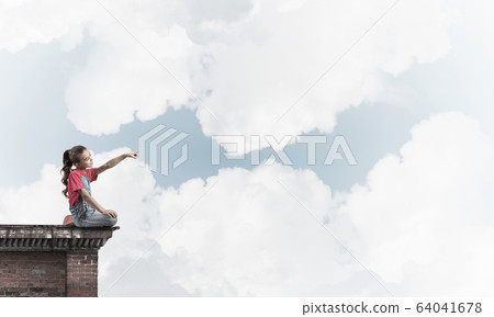 Concept of careless happy childhood with girl showing touch gest Concept of careless happy childhood with girl showing touch gest 64041678