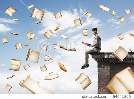 Man reading book and many of them flying in air Man reading book and many of them flying in air 64041800