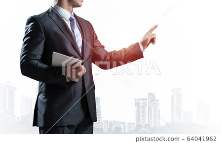 Business advisor standing and pointing copy space Business advisor standing and pointing copy space 64041962