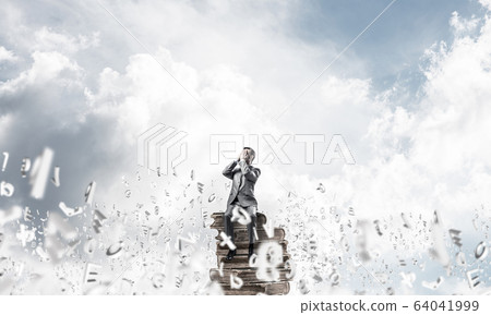 Young man floating in sky and do not want to see anything 64041999