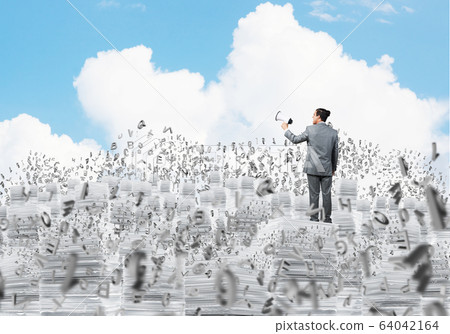 Businessman standing with megaphone. 64042164
