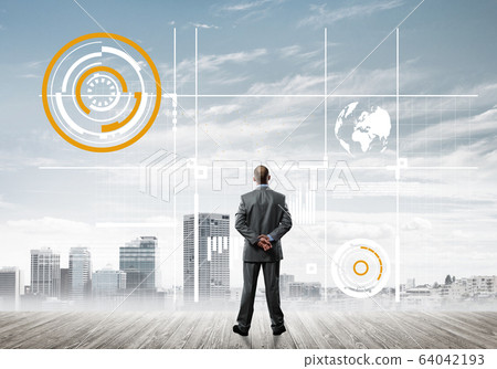 Pensive businessman looking at user interface against modern city background Pensive businessman looking at user interface against modern city background 64042193