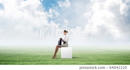 Attractive business lady or accountant outdoors on white box Attractive business lady or accountant outdoors on white box 64042220