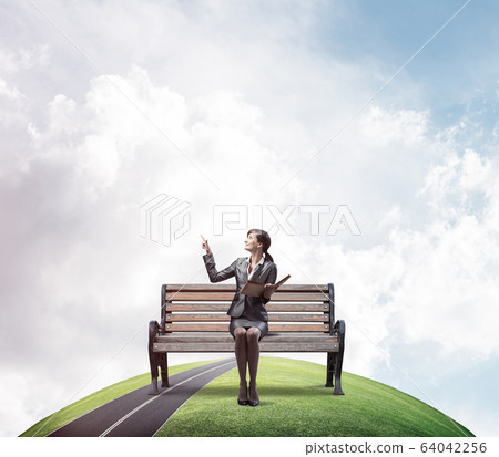 Young woman holding open book on wooden Young woman holding open book on wooden 64042256