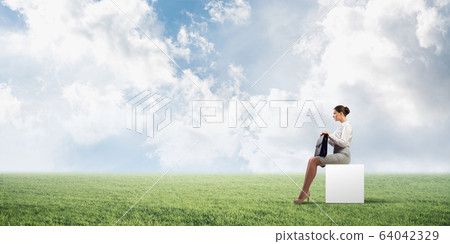 Attractive business lady or accountant outdoors on white box Attractive business lady or accountant outdoors on white box 64042329