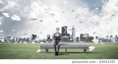 Young businessman or student studying the science and paper plan 64042385