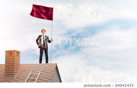 Young businessman with flag presenting concept of leadership. Mixed media 64042435