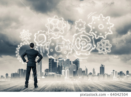 Cogwheel engine drawn on screen as symbol for teamwork and coope Cogwheel engine drawn on screen as symbol for teamwork and coope 64042504