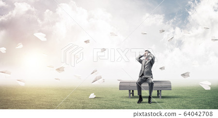 Young man in suit in park dont want to hear anything 64042708