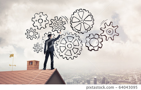 Mister boss on brick roof standing with back and draw teamwork c Mister boss on brick roof standing with back and draw teamwork c 64043095