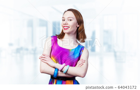 Happy woman standing with folded arms Happy woman standing with folded arms 64043172