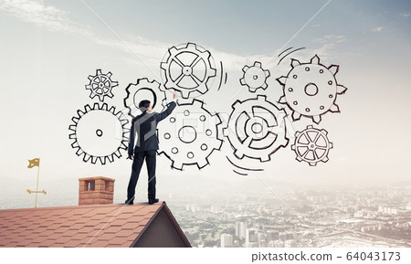 Mister boss on brick roof standing with back and draw teamwork c Mister boss on brick roof standing with back and draw teamwork c 64043173