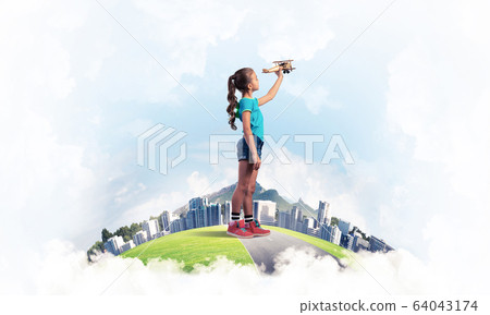 Concept of careless happy childhood with girl dreaming to become Concept of careless happy childhood with girl dreaming to become 64043174