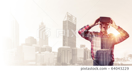 Guy wearing checked shirt and virtual mask demonstrating shock o Guy wearing checked shirt and virtual mask demonstrating shock o 64043229