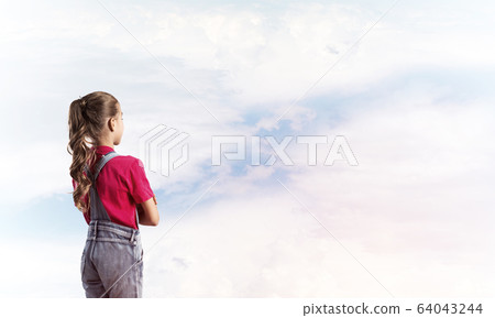 Concept of careless happy childhood with girl looking in future 64043244