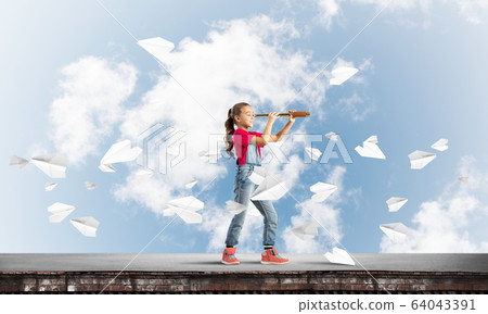 Concept of careless happy childhood with girl exploring this world 64043391