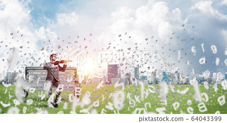 Handsome violinist in park on wooden bench and symbols fly around 64043399