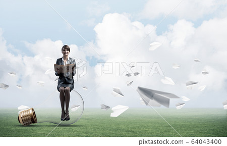 Young woman holding open book 64043400