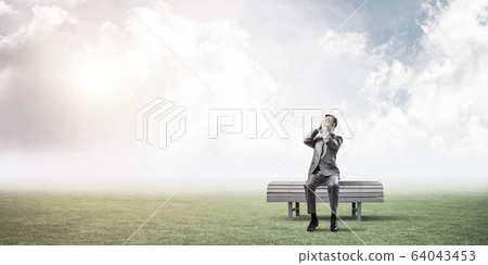 Young man in summer park on bench do not want to see anything Young man in summer park on bench do not want to see anything 64043453