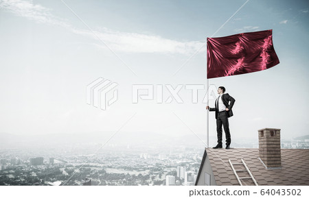 Young businessman with flag presenting concept of leadership. Mi Young businessman with flag presenting concept of leadership. Mi 64043502