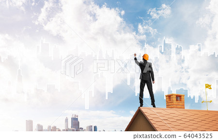 Man architect draw silhouette of modern city on blue sky. Mixed media Man architect draw silhouette of modern city on blue sky. Mixed media 64043525