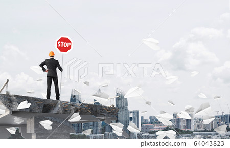 Confident engineer holding street safety sign. Confident engineer holding street safety sign. 64043823