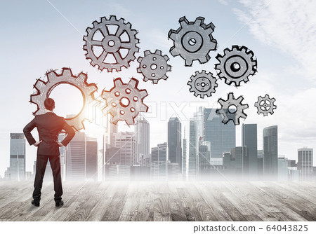 Cogwheel engine drawn on screen as symbol for teamwork and coope 64043825