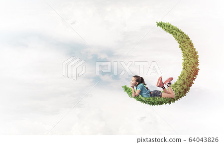 Concept of careless happy childhood with girl dreaming about som 64043826