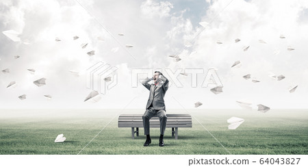 Young man in suit in park dont want to hear anything Young man in suit in park dont want to hear anything 64043827