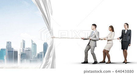 Young businesspeople working in collaboration and pulling white advertisement banner 64043880