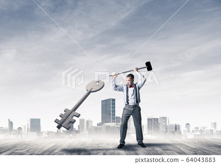 Breaking through access concept with furious man crashing concre Breaking through access concept with furious man crashing concre 64043883