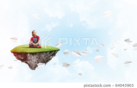 Concept of careless happy childhood with girl dreaming about something Concept of careless happy childhood with girl dreaming about something 64043903
