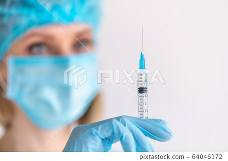 Syringe for injection in nurse hand. Medical glass Syringe for injection in nurse hand. Medical glass 64046172
