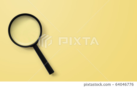 Magnifying glass on yellow colour background Magnifying glass on yellow colour background 64046776