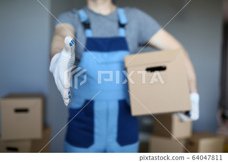 Male hand hold cardboard against new flat closeup Male hand hold cardboard against new flat closeup 64047811