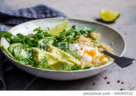 Quinoa salad with egg and avocado in gray bowl Quinoa salad with egg and avocado in gray bowl 64049352