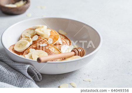Traditional pancakes with banana, almonds  64049356