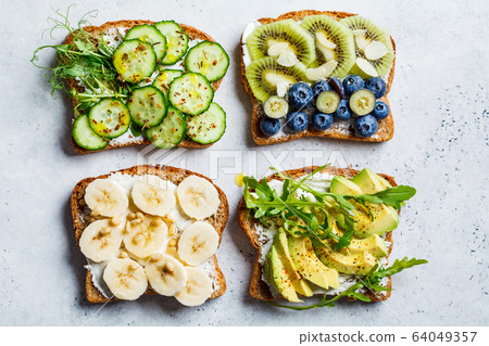Breakfast toasts with various healthy toppings. Breakfast toasts with various healthy toppings. 64049357