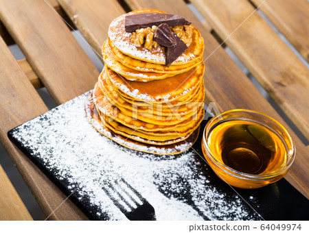Pancakes with honey and chocolate 64049974