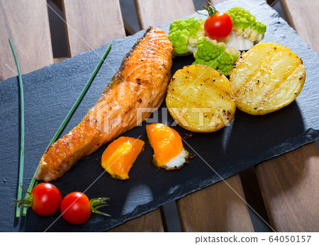 Grilled salmon with egg yolk and vegetables Grilled salmon with egg yolk and vegetables 64050157