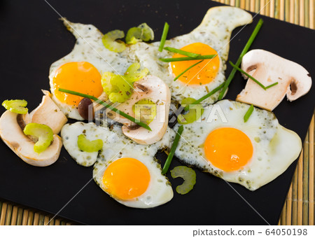 Fried quail eggs with champignons Fried quail eggs with champignons 64050198