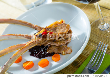 Baked lamb ribs with golden crust Baked lamb ribs with golden crust 64050425