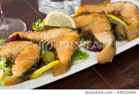 Slices of fried in flour sturgeon Slices of fried in flour sturgeon 64050469