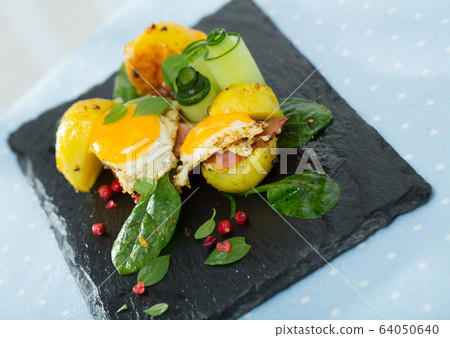 Plate with mini burgers from scrambled quail eggs with potatoes and greens Plate with mini burgers from scrambled quail eggs with potatoes and greens 64050640