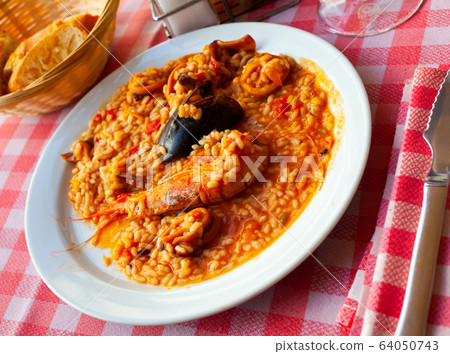 Paella with shrimps and mussels Paella with shrimps and mussels 64050743