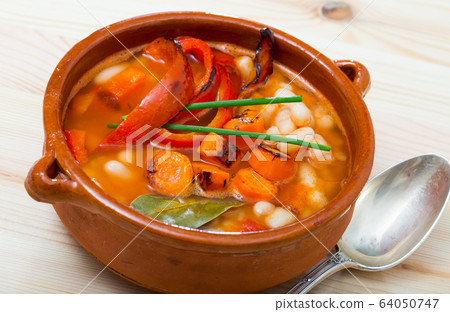 Soup of bean with boiled carrots, pepper and greens, served in bowl Soup of bean with boiled carrots, pepper and greens, served in bowl 64050747